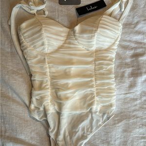 White bodysuit with tie straps. Never worn.